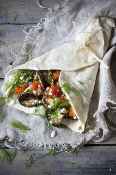 flatbread roll with grilled eggplants tomatoes, herb and yogurt