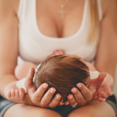 The mother, holding a head of his newborn son