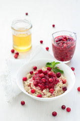 Oatmeal with cranberry jam, fresh cranberries and honey