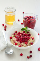 Oatmeal with cranberry jam, fresh cranberries and honey