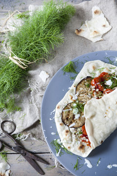 flatbread with grilled eggplants tomatoes fennel herb and yogurt