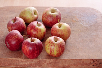 Rustic apples on wooden board