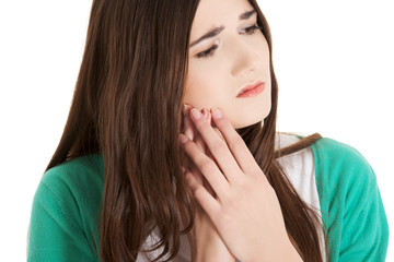 Teen woman having a terrible tooth ache.