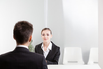 Business people having job interview with young woman - 70369338