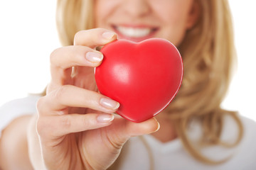 Smiling woman with red heart