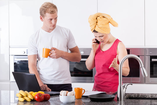 Busy Couple In The Morning In Kitchen