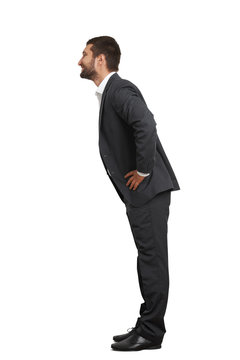 Man In Black Suit Leaning Forward