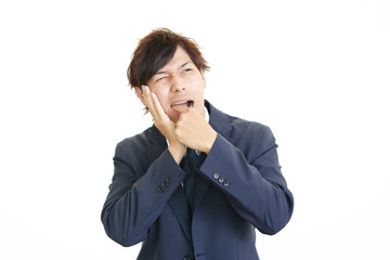 歯痛を訴えるビジネスマン