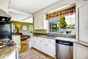 White kitchen cabinets with granite tops