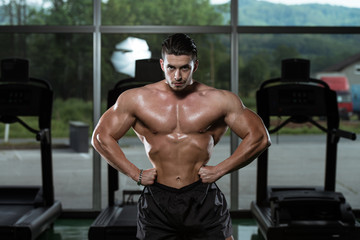 Fototapeta na wymiar Male Bodybuilder Flexing Muscles