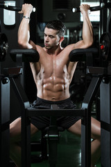 Fototapeta na wymiar Young Man Doing Heavy Weight Exercise For Biceps