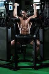 Fototapeta na wymiar Man Bodybuilder Doing Exercise For Biceps