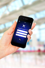 hand holding mobile phone with flights search application