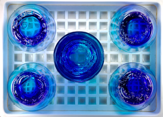 Blue glass lay on trays.