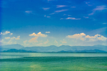 Seascape and mountain on bluesky background.