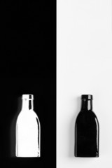negative reflection of the vintage  small black bottle