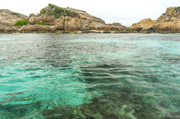Fototapeta premium Rock island and clear water with low angle view