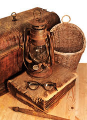 Old book, basket and glasses isolated on white background