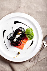 Cuttlefish ink paste with cream sauce and salmon