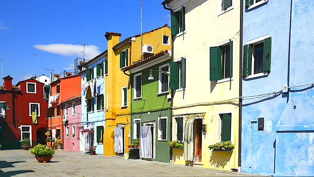 Colorful buildings in Burano island sunny street, Venise, Italy