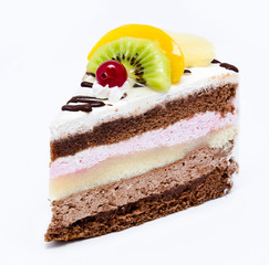 Piece of chocolate cake with icing and fresh fruit isolated on a