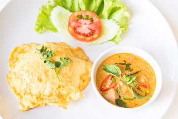 Delicious rice and red curry with pork and omelet (Thai panang c