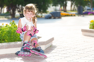 cute happy child girl roller skating on natural background