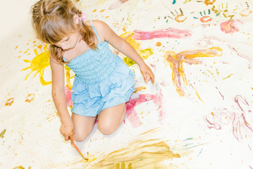 cute young child girl painting over white