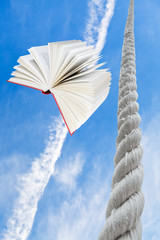 flying book and rope rises to blue sky