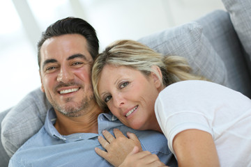 Fototapeta premium Mature couple relaxing in sofa at home