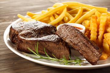 Grilled steak, chips and vegetables