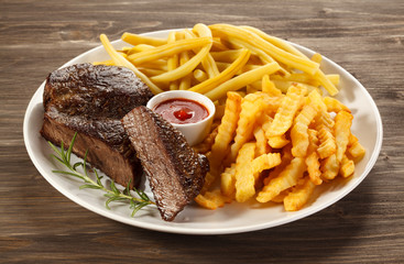 Grilled steak, chips and vegetables
