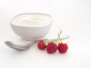 Natural yoghourt, yoghurt with raspberries and spoon over white