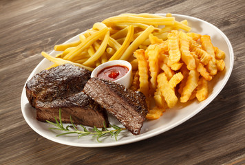 Grilled steak, chips and vegetables