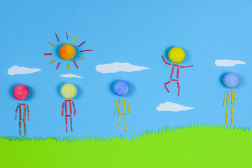 Fototapeta na wymiar Figurative people standing on grass against blue sky.