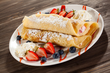Pancakes with cream and strawberries