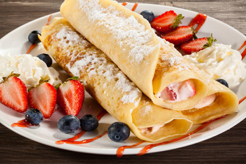Pancakes with cream and strawberries