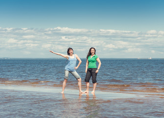 Two happy women in the water of sea