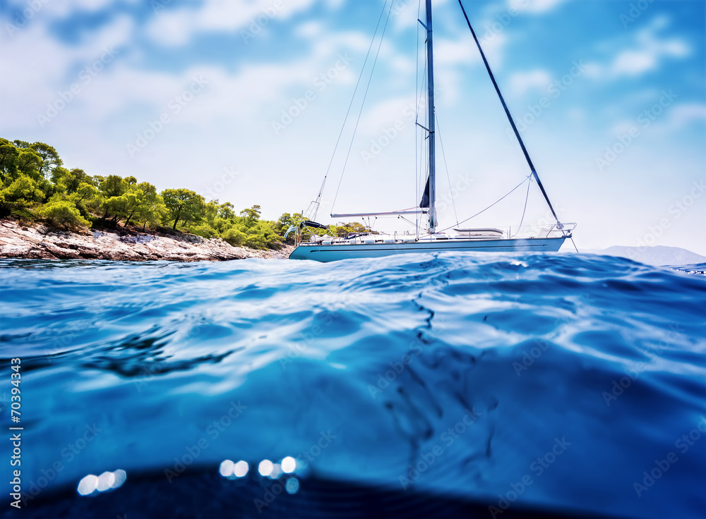 Wall mural Luxury sailboat near tropical island