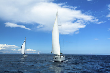Fototapeta na wymiar Yachting in the wind through the waves. Sailing. Luxury yachts.