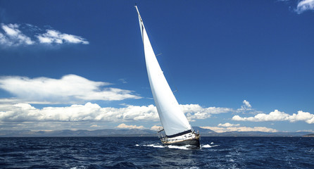 Fototapeta na wymiar Lonely sailboat at sea. Romantic trip luxury yacht.