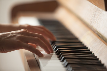 woman hands playing piano