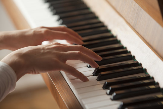 Woman Hands Playing Piano