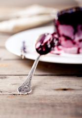 Berry ice cream with topping on a white plate