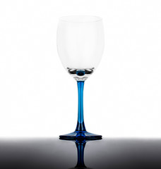 Empty wine glass on a white background with reflection