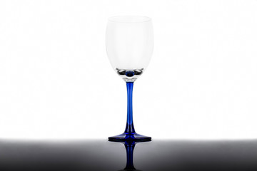 Empty wine glass on a white background with reflection