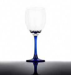 Empty wine glass on a white background with reflection