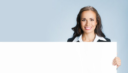 Businesswoman showing signboard, over blue