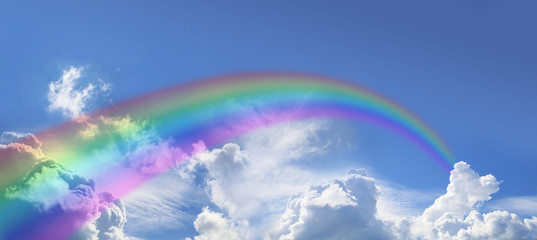 Wide blue sky and huge arcing rainbow