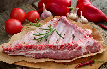 The Ribs on a board with vegetables.